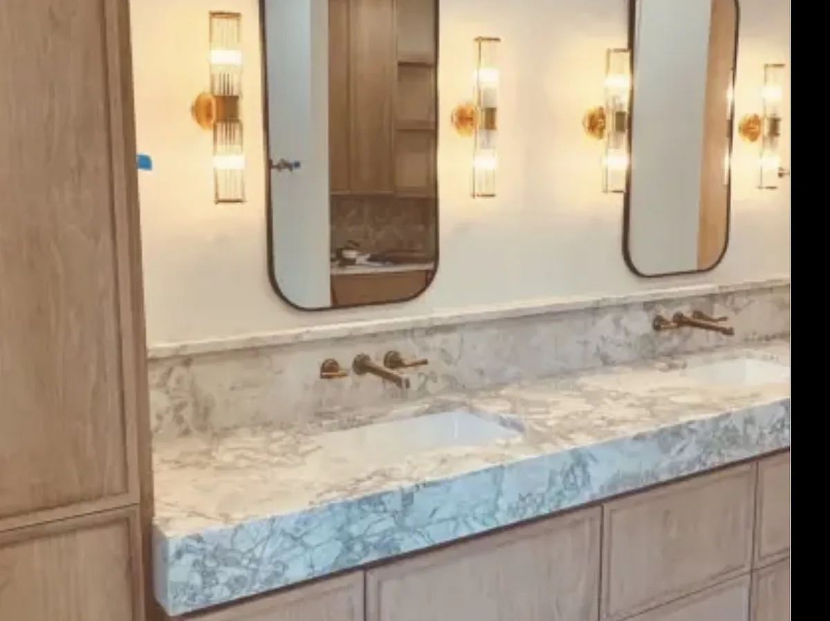 Bathroom with a double vanity and wall sconces