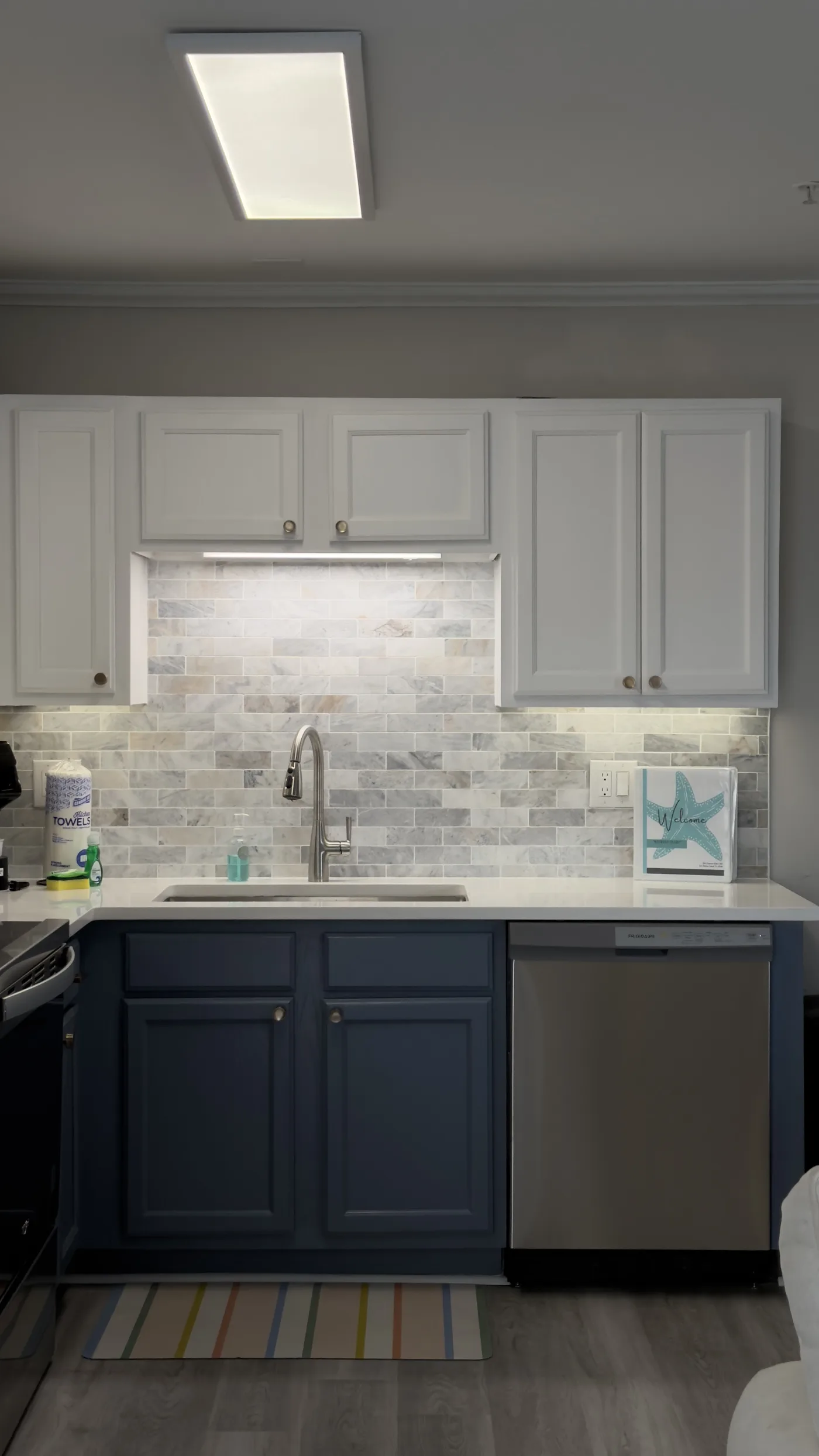 Kitchen with navy cabinets and a white countertop
